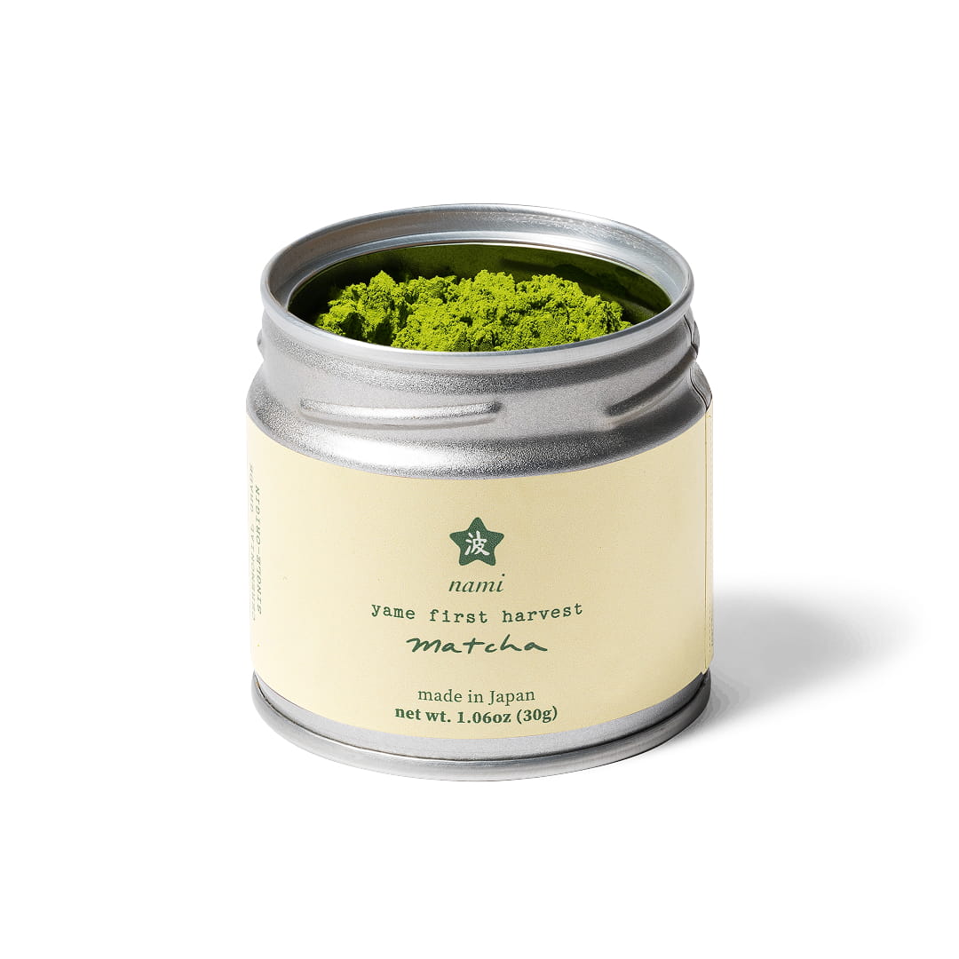 Opened tin of matcha with white label on white background with soft shadow