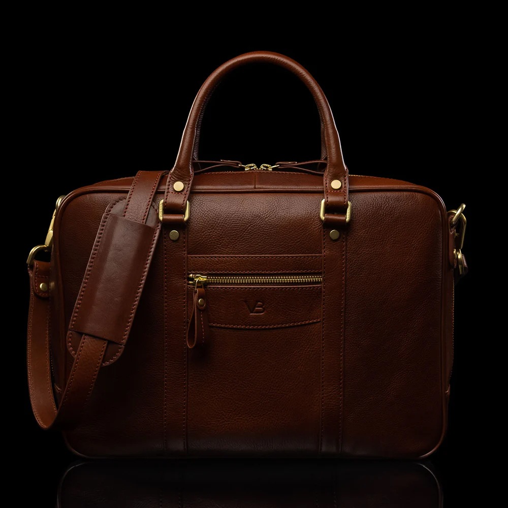 brown leather bag shot on a black background