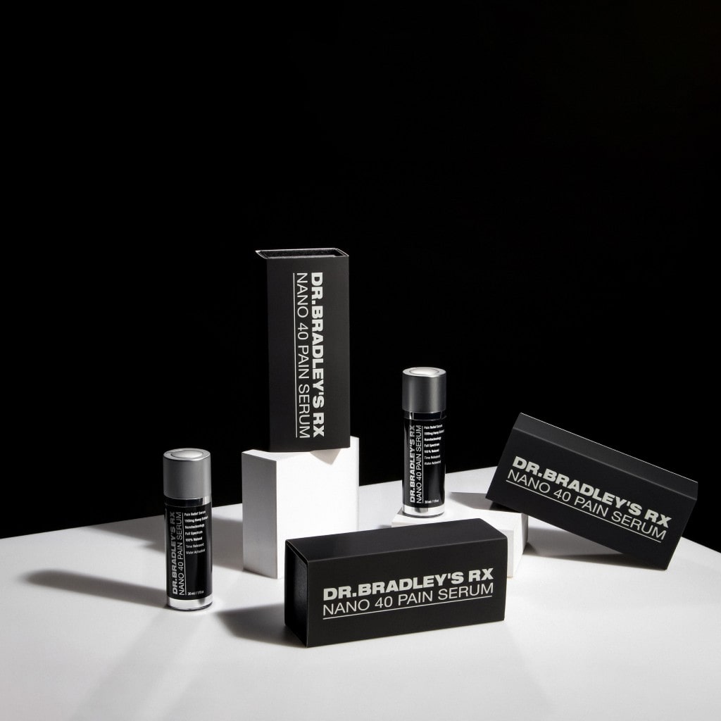 Minimalist flat lay of black-and-white skincare and makeup products arranged on a clean surface.
