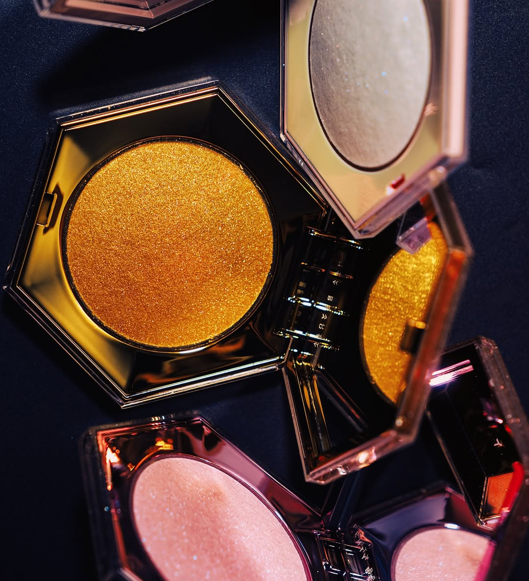 Close-up of colorful makeup powders arranged in open compacts